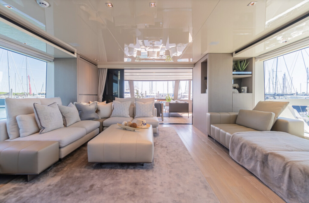 Interior view of a yacht with sofas and large windows