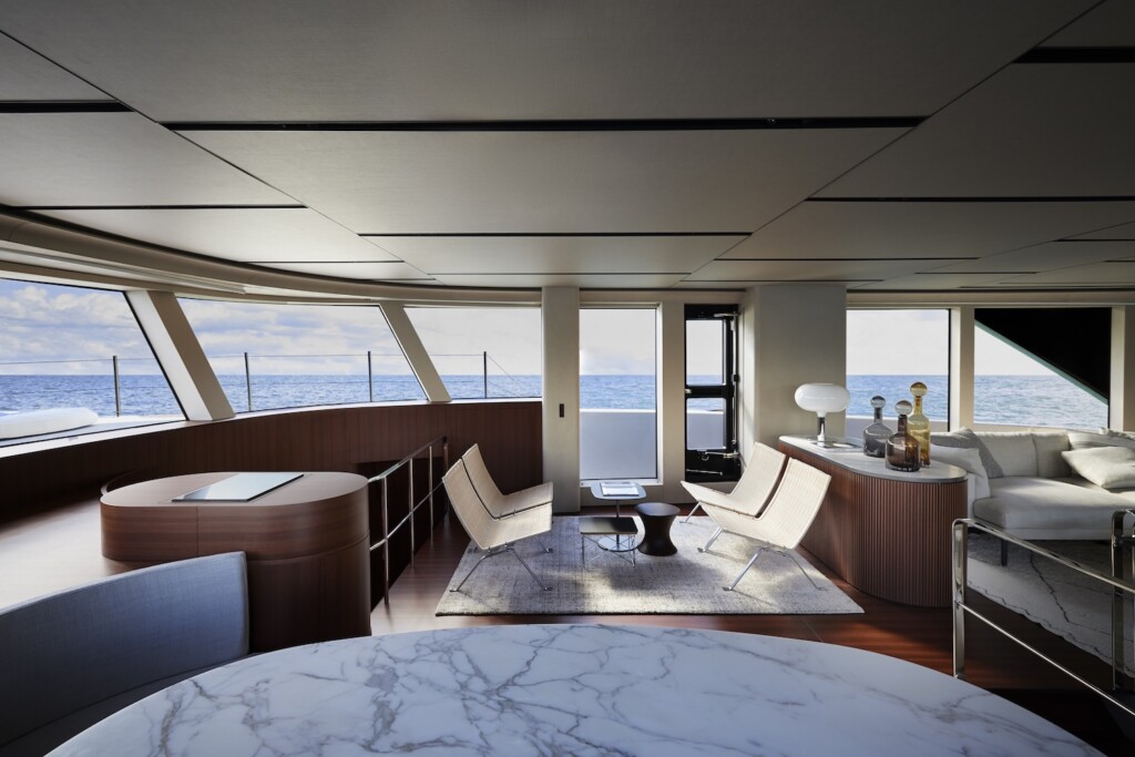 Interior view of the main deck of a catamaran with marble toped table and leather chairs